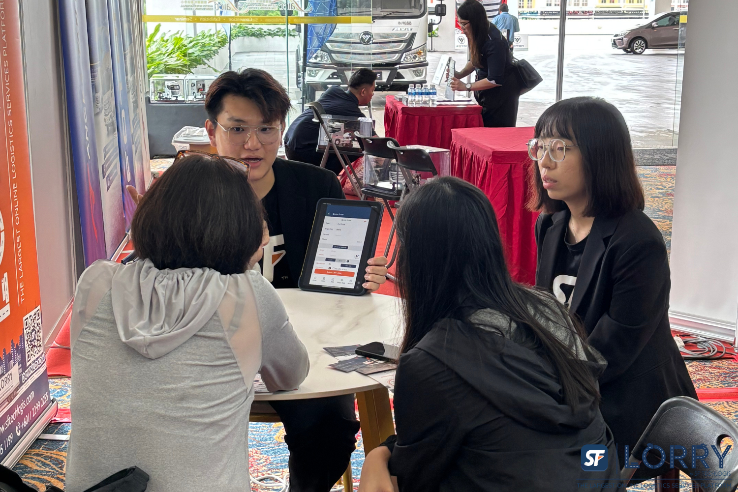 SF Lorry team presenting digital truck Malaysia solutions at Johor logistics exhibition 2024